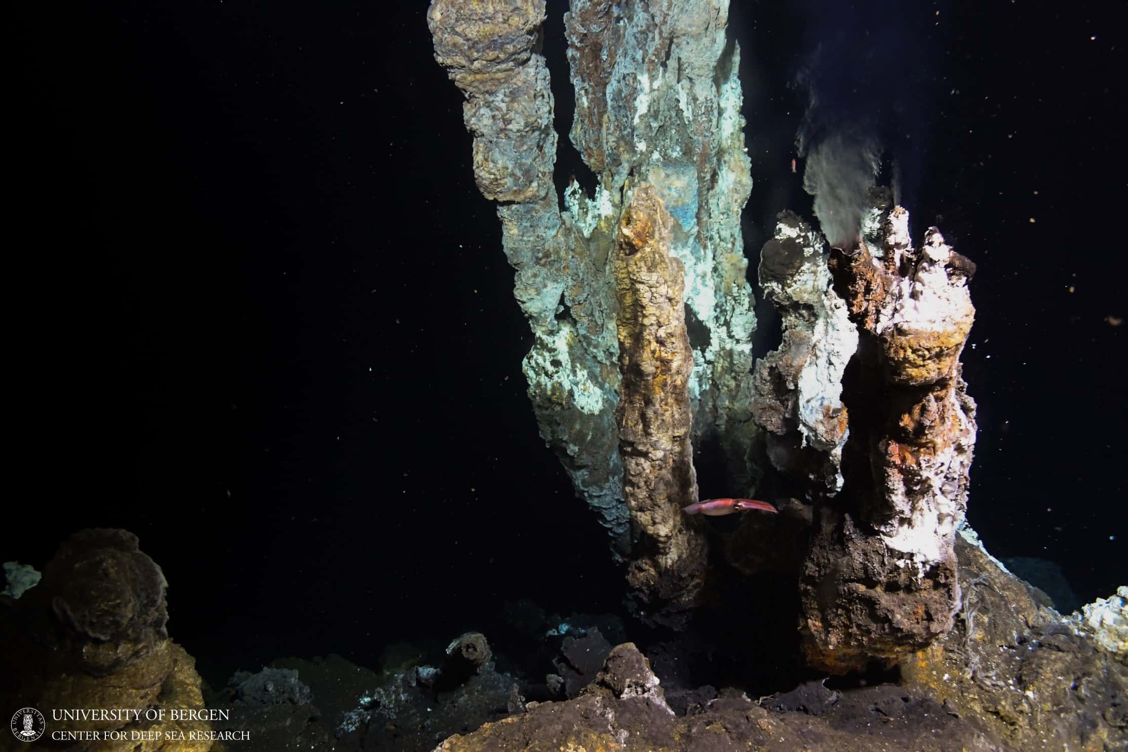 Blue and brown rock formations against a black background